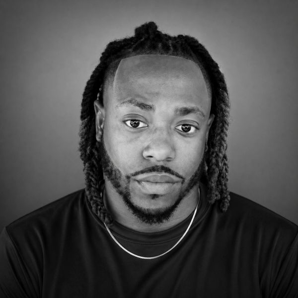 Black and white portrait of a man with styled hair and beard.