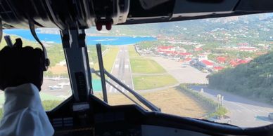 Cockpit view of aircraft landing on the Island of St. Barts.
