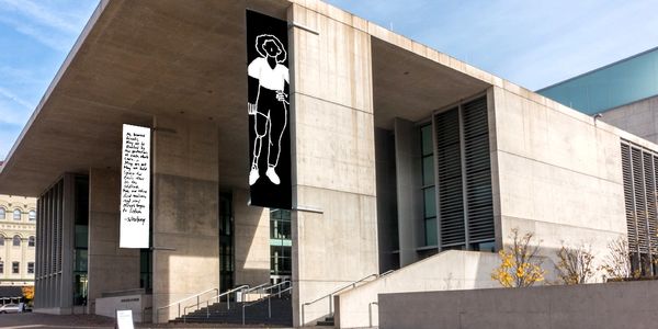 Exterior of an modern art museum with 25 foot black and white Dearest Friends banners