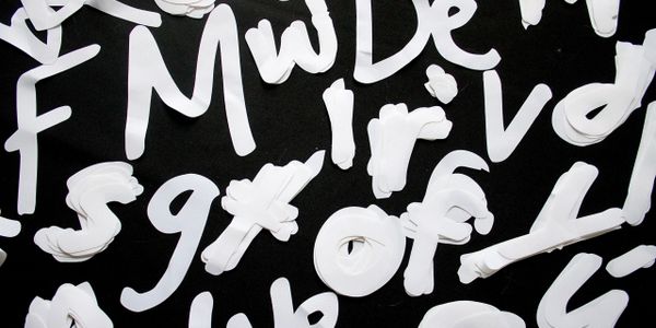 Collection of white fabric letters laser cut from weather-proof fabric