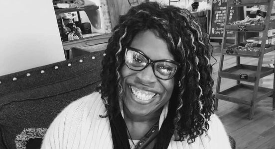 Lady smiling while eating a cookie