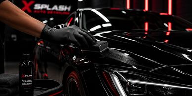 Person applying ceramic coating on black car.
