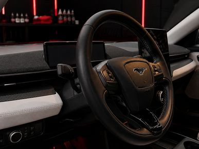 Interior view of a Ford Mustang steering wheel and dashboard.