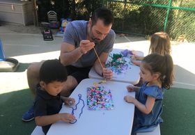 dad and three kids with arts and crafts