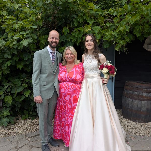 Tracy Morgan of TSM Celebrant Ceremonies, standing between bride and groom