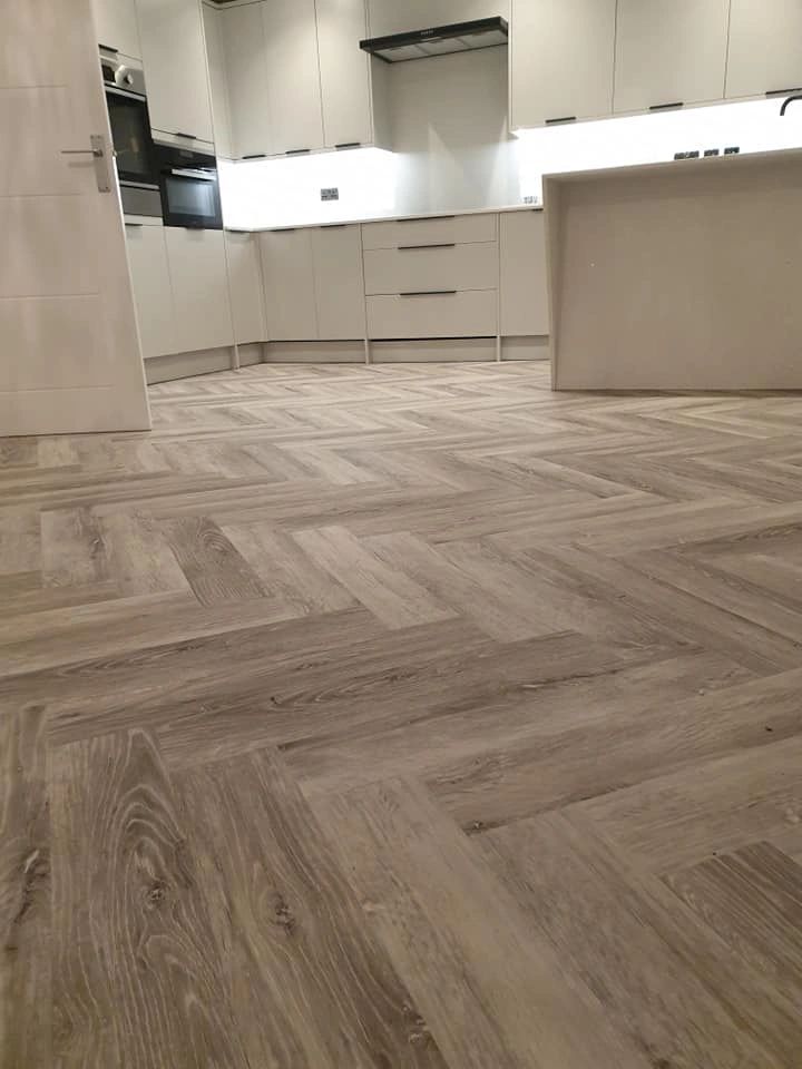 LVT Herringbone flooring. Kitchen, Family Room, Hallway. Sub floor leveled using Jumpax system