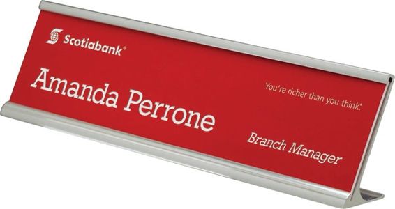 Angled metal desk nameplate bracket with red plastic nameplate
