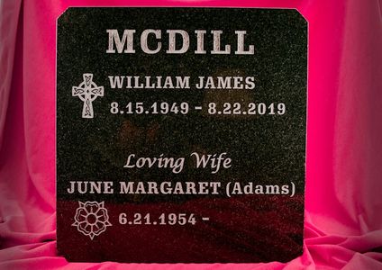 Engraved black granite columbarium door.