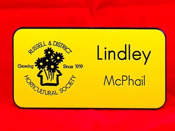 Yellow plastic name badge for community organization