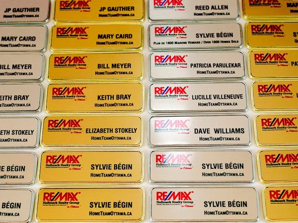 Sublimated metal name tags with frame for real estate broker