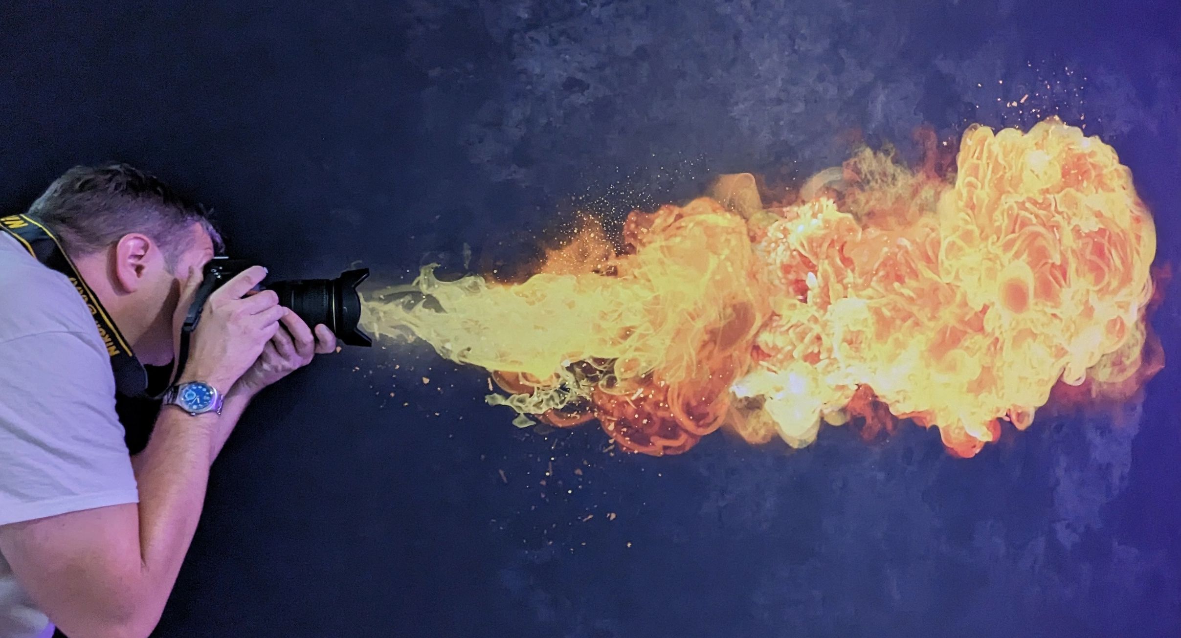 Photographer with flames shooting from the lens
