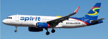 Spirit Airlines Airbus A320 flying against a clear blue sky.