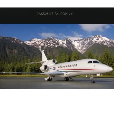 Dassault Falcon 7X business jet parked with scenic snowy mountains in the background.