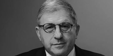 Black and white portrait of a man with glasses.
