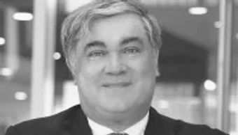 Smiling middle-aged man in suit.
