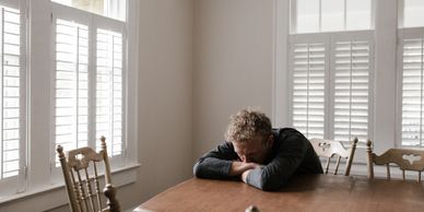 anxious man sitting at kitchen table