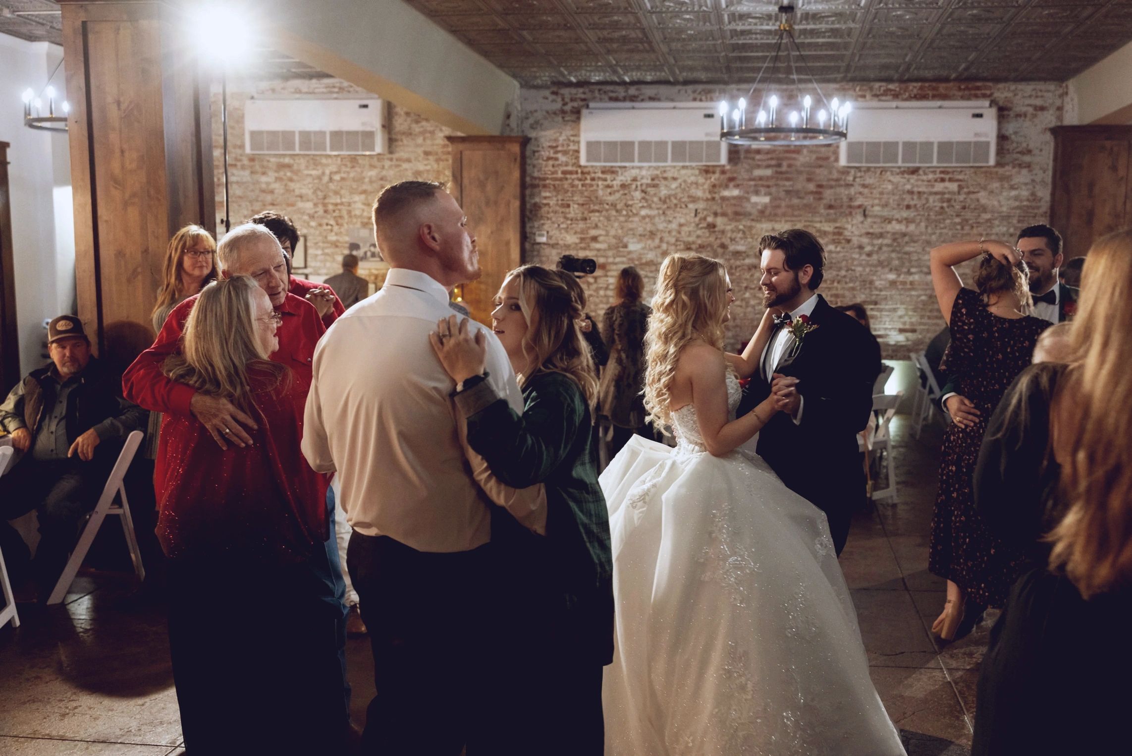 Wedding reception dance floor with couples dancing indoors, celebrating while the event runs smooth.