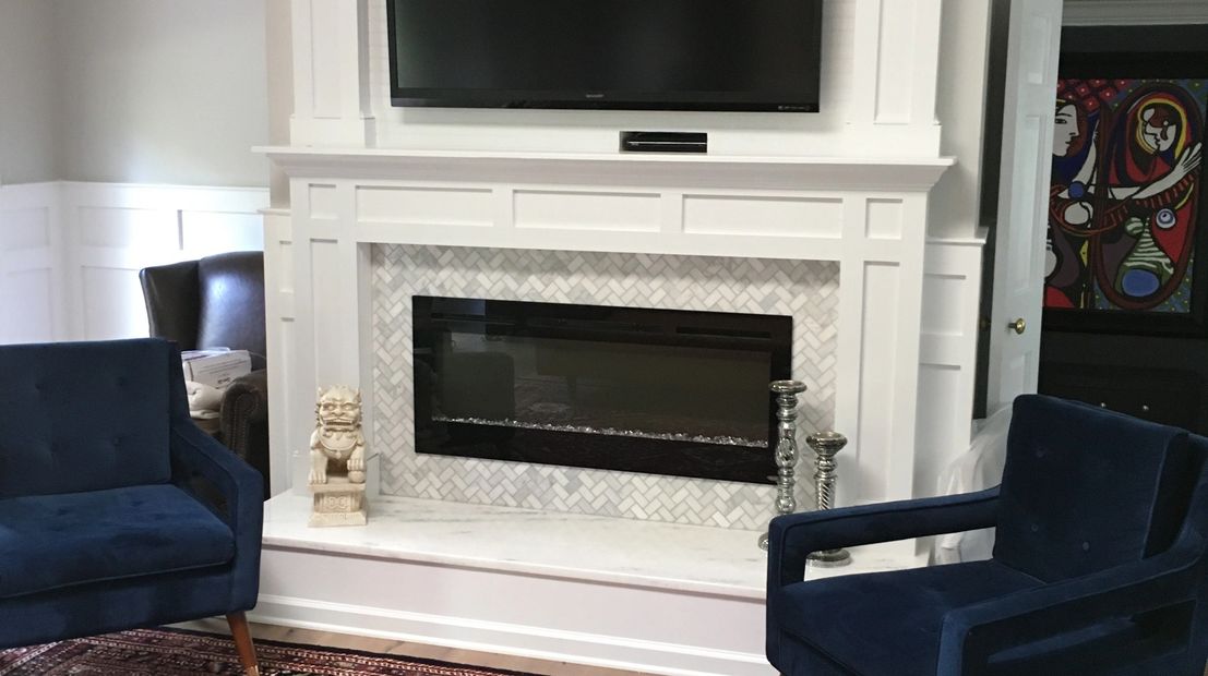 From a plain wall with nothing on it to a Custom built Fireplace and Mantel