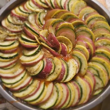 Ratatouille .... Squash, Zucchini, red potatoes on a bed of sauteed onions & marinara - oven baked