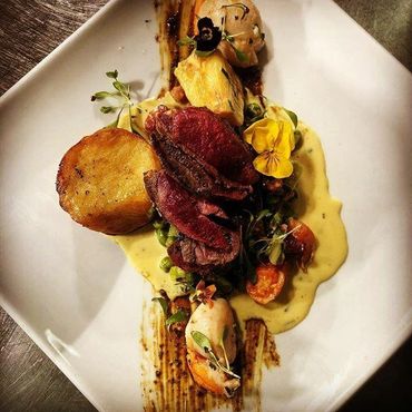 Picture of seared pigeon breast and kings scallops with fondant potato