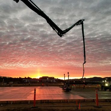 Concrete pumping a slab with a sunsetting view