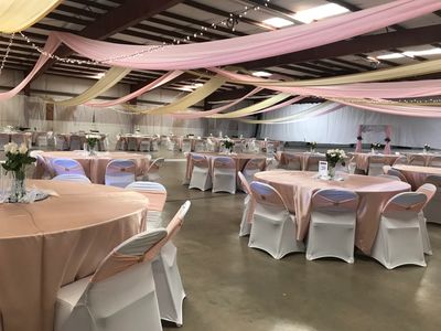 tables decorated for wedding in large building