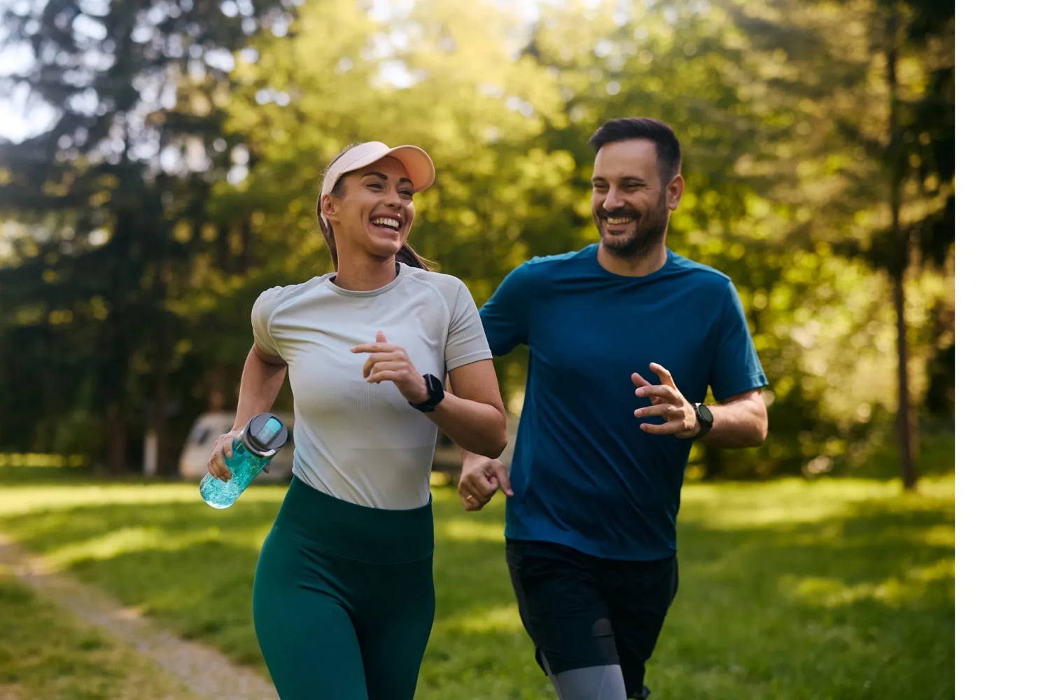 A happy couple jogging together outdoors on a sunny day.