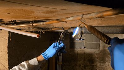 Liberty Plumbing technician soldering copper pipe during an emergency repair in Ellington, CT