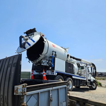 Jet-vac truck dumping into a bin.