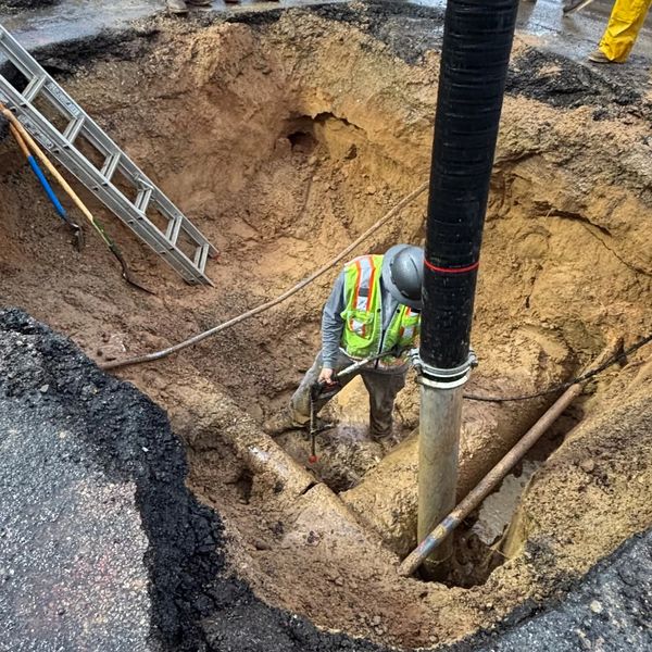 A worker hydro excavating.