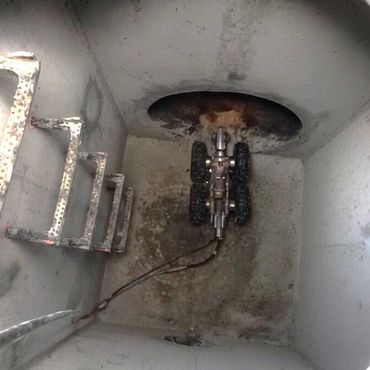 Pipeline inspection robot in storm drain manhole.