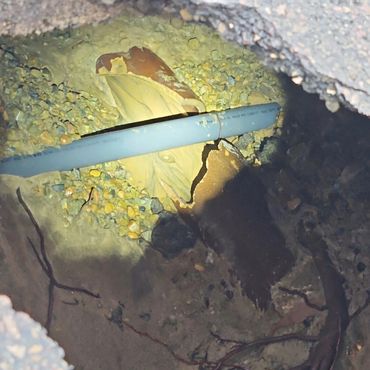 Broken sewer pipe inside of a sink hole.