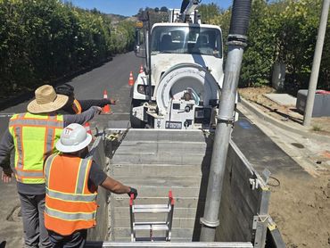 Construction crew planning the next steps of pipe repair.