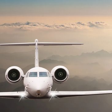 Plane Flying over cloudy mountains.