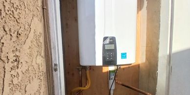 Tankless water heater installed in a small closet.