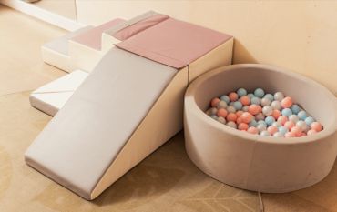 Soft play area with ramp and ball pit.