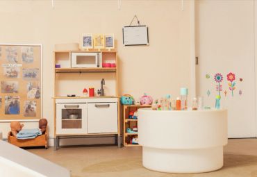 Cozy children's play kitchen area with toys and colorful decorations.