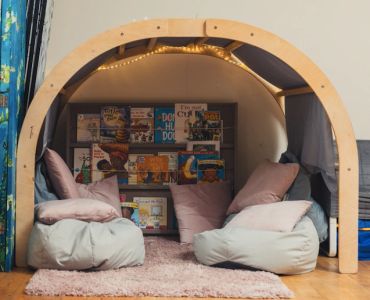 Cozy reading nook with bean bags and books.