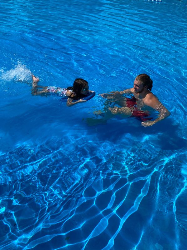 One of our swim instructors, Ciaran, working with one of his students on kicking in the water. 