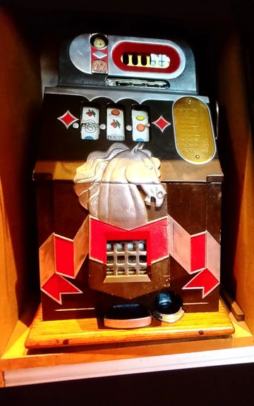 Vintage slot machine with horse motif and colorful symbols.
