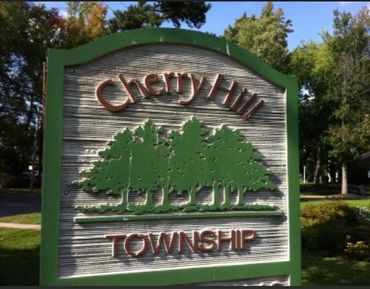 Signboard for Cherry Hill Township with tree graphics.