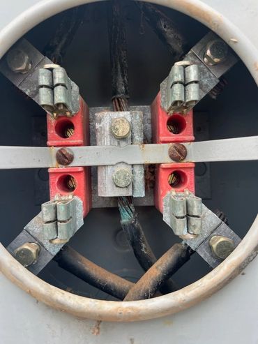 Close-up of electrical meter base needing replacement