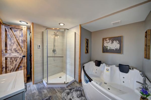 Modern bathroom with glass shower and Jacuzzi tub.