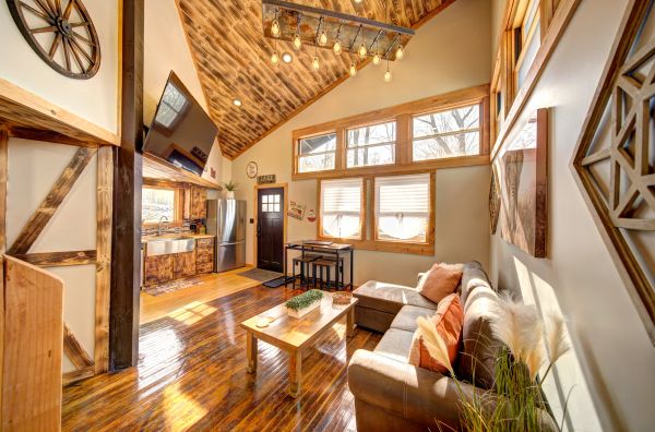 Cozy rustic living room with wooden accents and a loft ceiling.