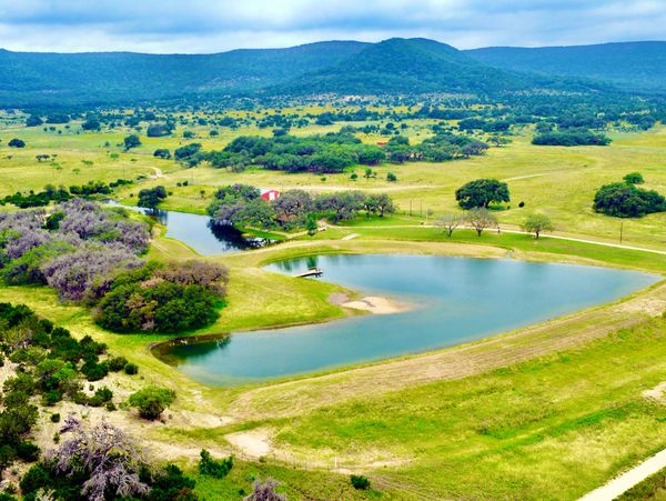 Picturesque lake built by 3R Sodbusters in the foothills of the Hill Country.