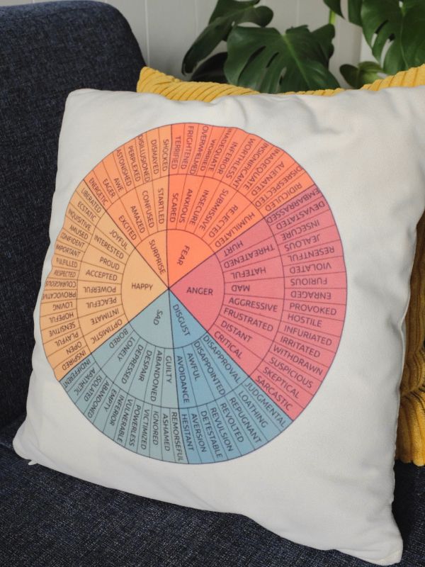 Pillow with a colorful emotion wheel chart.