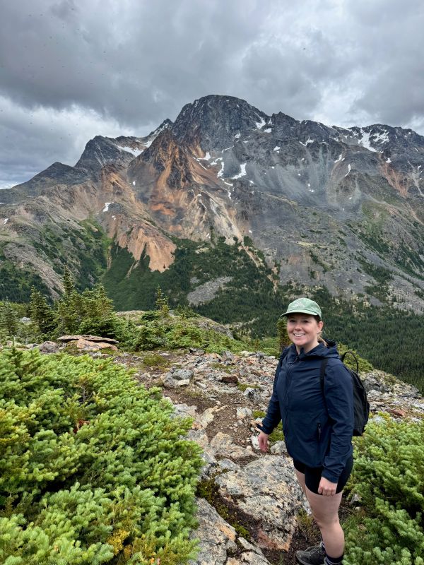 Smiling woman hiking in the mountains.