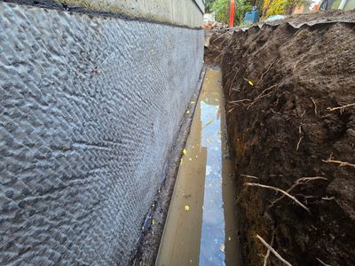 Excavated trench beside a foundation for drainage installation and repair in Nanaimo, BC.