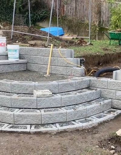 Block retaining wall installation in Nanaimo with drainage and base preparation.