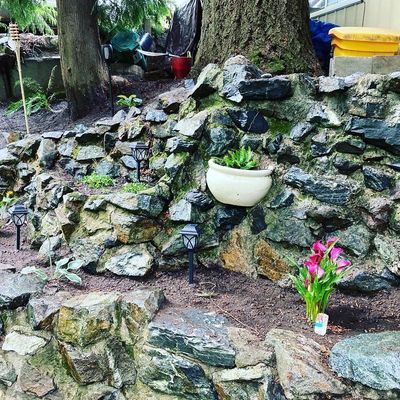 Rock wall, garden bed clean up, replanted plants and top soil 